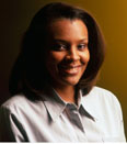 woman wearing a button down shirt, smiling