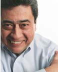 man wearing a button down shirt, with a smile